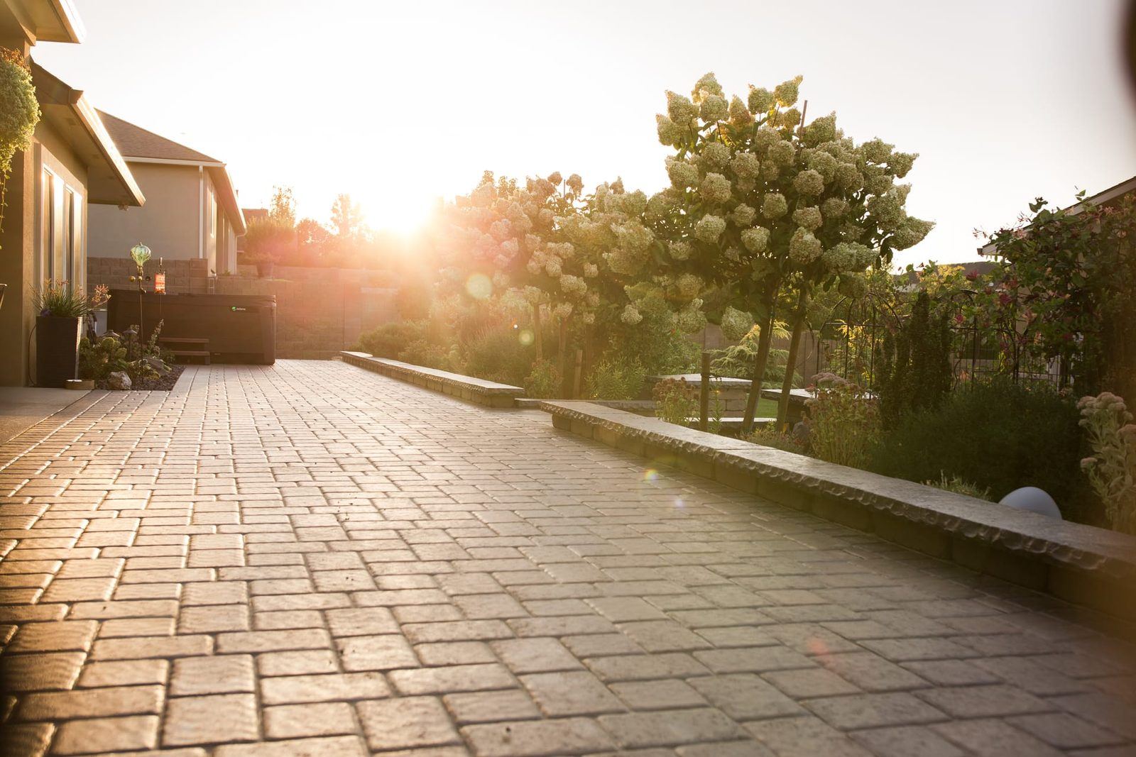 Paver patio and seat wall glowing at sunset in a Tri-Cities backyard