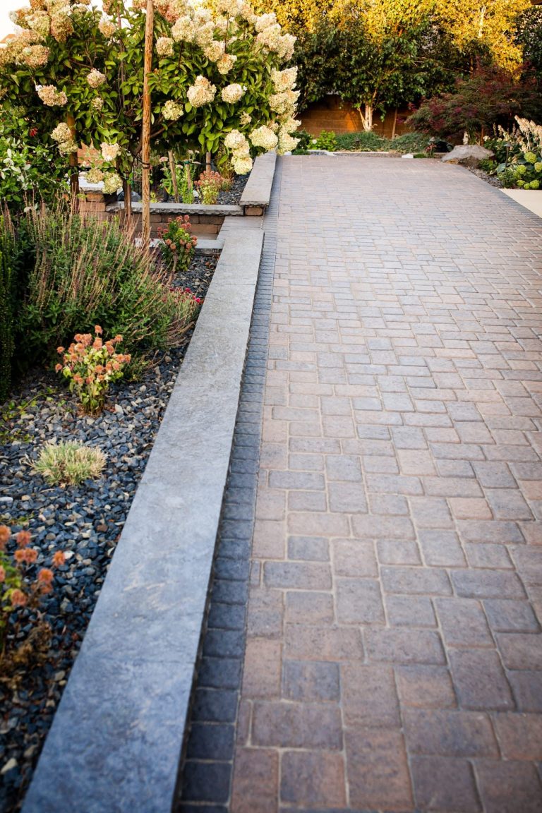 Finished paver patio and walkway with garden beds