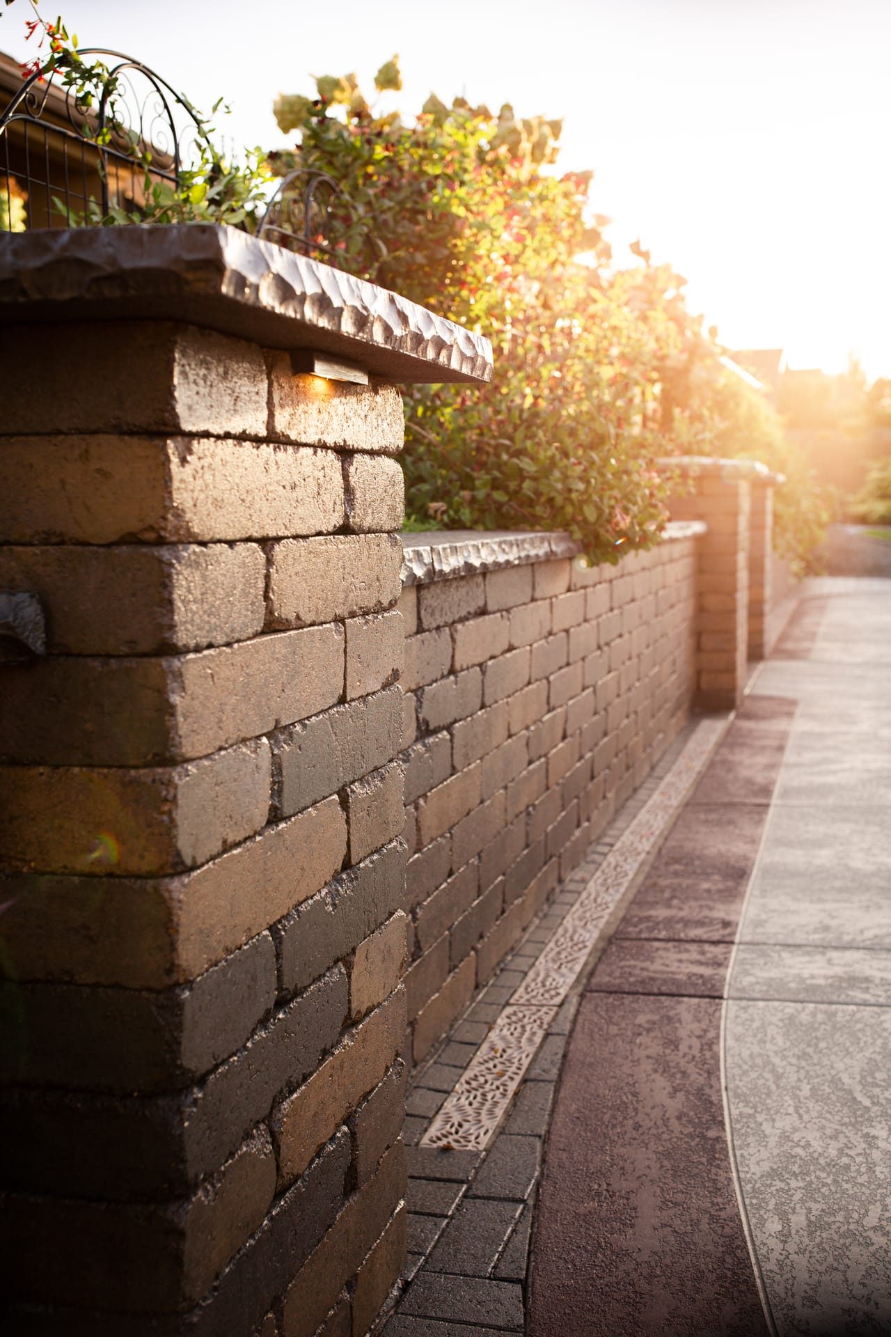 Segmental block retaining wall holding a terraced landscape bed